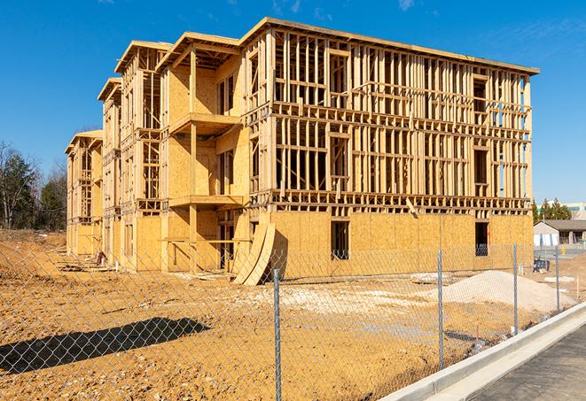 a close-up of temporary chain link fences enclosing a job site, signaling progress in the project's development in Berkeley